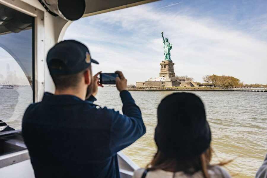 NYC: Wall Street Tour with 9/11 Memorial and Statue Ferry - Taking the ferry to Liberty Island